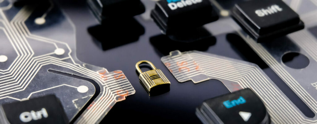 image of small lock on a motherboard among keyboard keys promoting cybersecurity framework