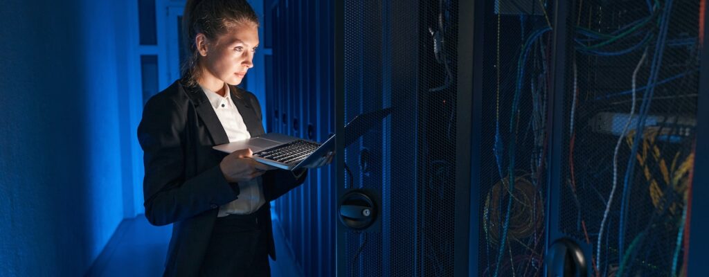 woman working in server room improving cybersecurity for employees