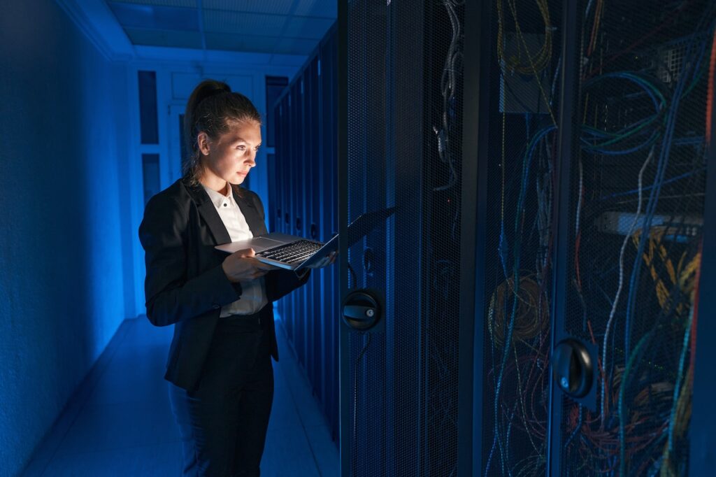 woman working in server room improving cybersecurity for employees