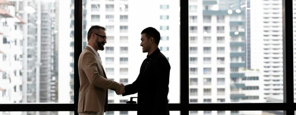 businessman building customer trust and shaking hands with client
